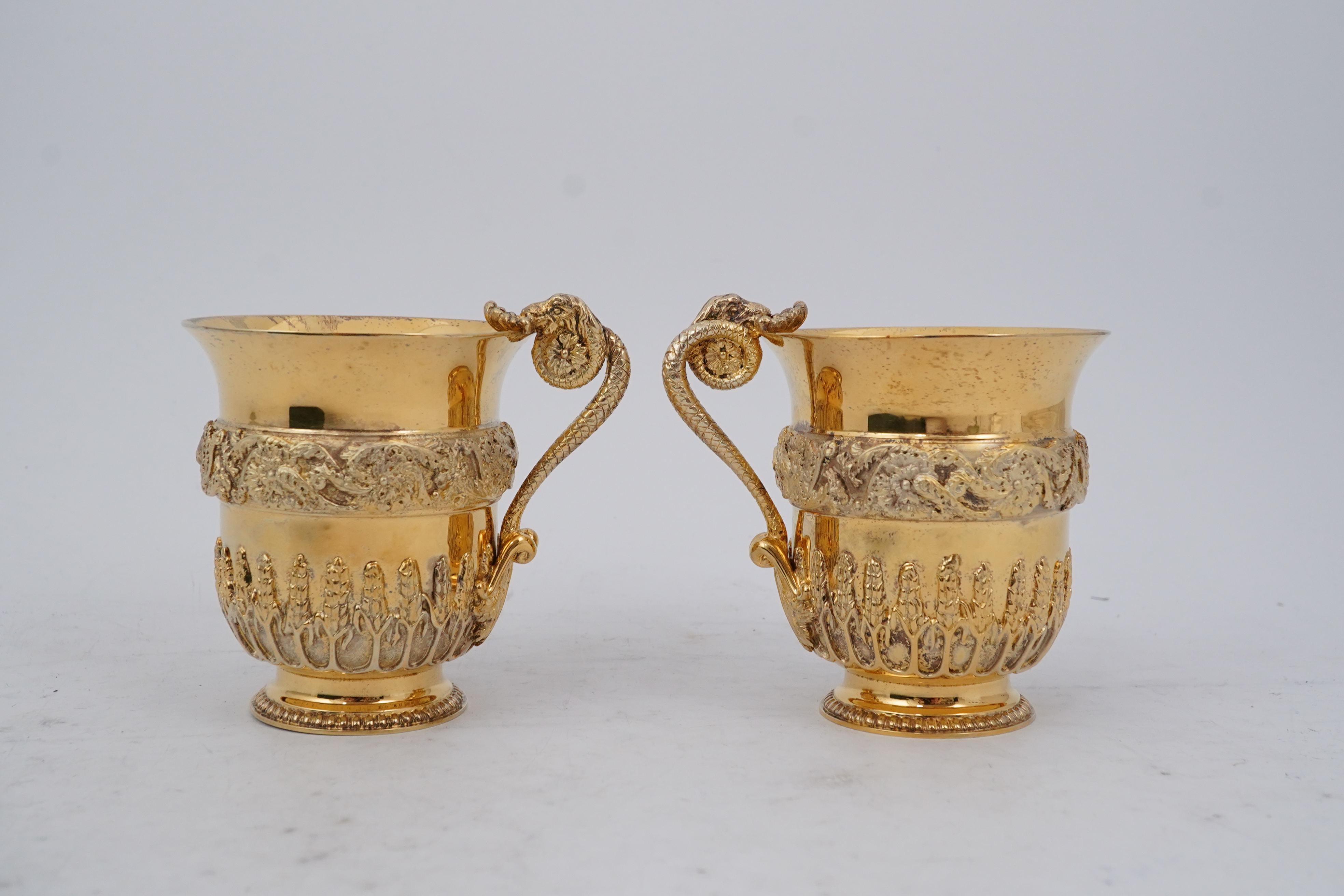 An ornate pair of Elizabeth II silver gilt cups, by Richard O.A. Jarvis